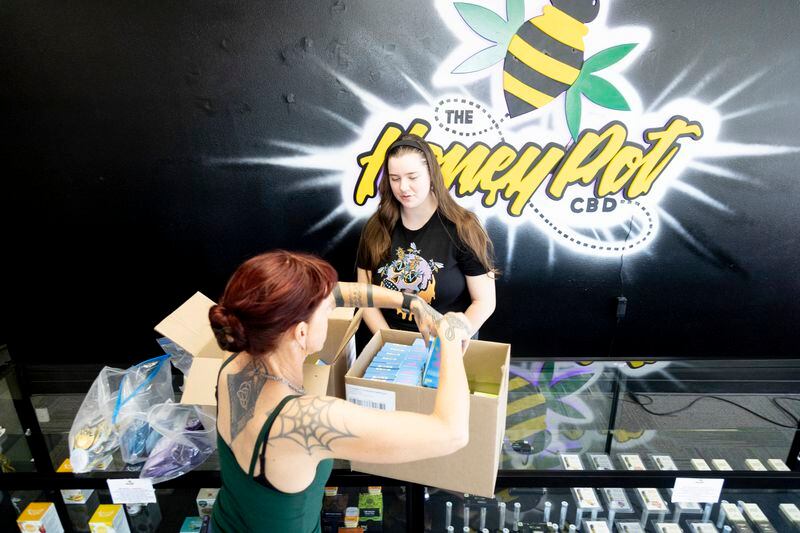 Jen Martindale delivers reproductive health materials to Mavie King, employee of The HoneyPot CBD store in Boise, Idaho, on Saturday, April 13, 2024. "It's a community responsibility," Martindale says. (AP Photo/Kyle Green)
