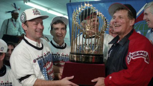 We are the champions!! Braves manager Bobby Cox (right) holds the championship trophy along with (from left) Stan Kasten, John Schuerholz and owner Ted Turner after winning the 1995 World Series. The Braves defeated the Cleveland Indians 1-0 in Game 6 on Oct. 28, 1995 to win the best-of-seven series four games to two. (From the files of the Atlanta Journal-Constitution)