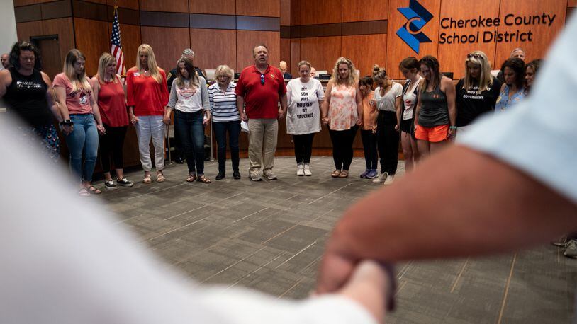 210520-Canton-People gather for a prayer before the beginning of the Cherokee County School Board on Thursday night, May 20, 2021. Ben Gray for the Atlanta Journal-Constitution