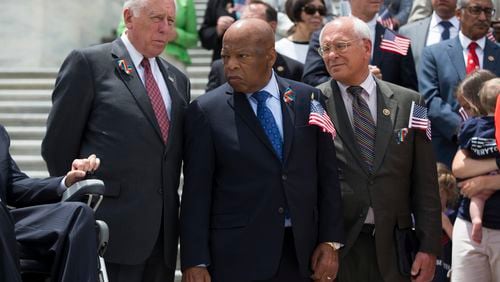 Rep. John Lewis, D-Ga., , flanked by House Minority Whip Steny Hoyer of Md., left, and Rep. Paul Tonko, D-N.Y., participate in a news conference on gun legislation, Wednesday, June 22, 2016, on Capitol Hill in Washington. (AP Photo/Evan Vucci)