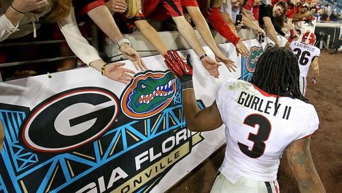 Georgia will wear white jerseys in Saturday's game against Florida, its first time in white jerseys against the Gators since the Todd Gurley-led Dogs won 23-20 in 2013. AJC file photo/Jason Getz