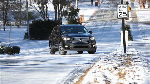 January 8, 2017, Canton: A motorist slips back down Pine Terrace Road unable to make it up the ice covered road in Cherokee Falls Estates at the Lake on Sunday, Jan. 8, 2017, in Canton. Secondary roads are still a safety concern for motorists.   Curtis Compton/ccompton@ajc.com