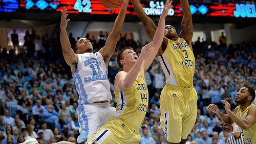 CHAPEL HILL, NC - JANUARY 02: Brice Johnson #11 of the North Carolina Tar Heels battles Ben Lammers #44 and Marcus Georges-Hunt #3 of the Georgia Tech Yellow Jackets for a rebound during their game at the Dean Smith Center on January 2, 2016 in Chapel Hill, North Carolina. North Carolina won 86-78. (Photo by Grant Halverson/Getty Images)