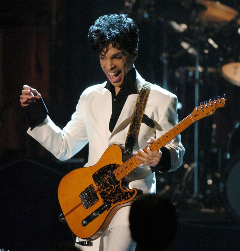 Prince performs on March 15, 2004, at the Waldorf Astoria Hotel in New York City, after being inducted into the Rock and Roll Hall of Fame. KEVIN MAZUR / ASSOCIATED PRESS FILE