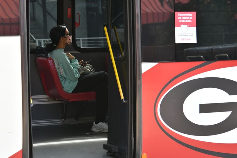 A student wears a face mask as she sits in an University of Georgia bus on the campus in Athens on Wednesday, September 23, 2020. (Hyosub Shin / Hyosub.Shin@ajc.com)