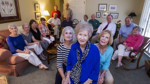 Karen McGehee, center, flanked by her friends Julianne Lovett, left, and Kay Allen, along with the rest of her friends at her home in Tallahassee. McGehee is the mother of Caroline Small who was shot and killed by police in Brunswick, Ga., in 2010. MARK WALLHEISER / SPECIAL