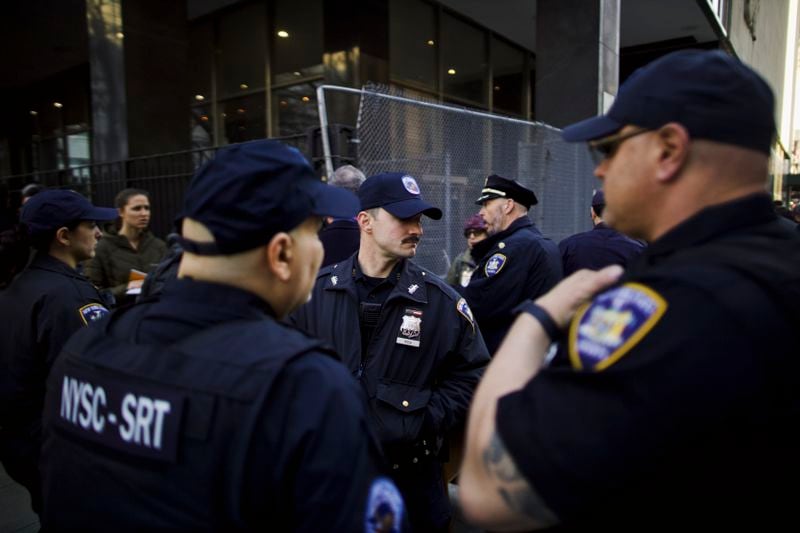 
                        New York State Courts police officers gather Tuesday morning outside Manhattan Criminal Court, where former President Donald Trump is expected to be arraigned Tuesday, in Manhattan, April 4, 2023. The former president is expected to appear today in a Manhattan courtroom and plead not guilty to charges related to his role in a hush-money payment to a porn star in the last days of the 2016 presidential campaign. (Ahmed Gaber/The New York Times)
                      