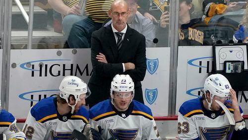 FILE - St. Louis Blues interim head coach Drew Bannister stands behind the bench during the first period of an NHL hockey game against the Pittsburgh Penguins, Saturday, Dec. 30, 2023, in Pittsburgh. The St. Louis Blues have removed the interim tag from Drew Bannister’s title and named him their full-time coach. President of hockey operations and general manager Doug Armstrong announced the move Tuesday, May 7, 2024.(AP Photo/Matt Freed, File)