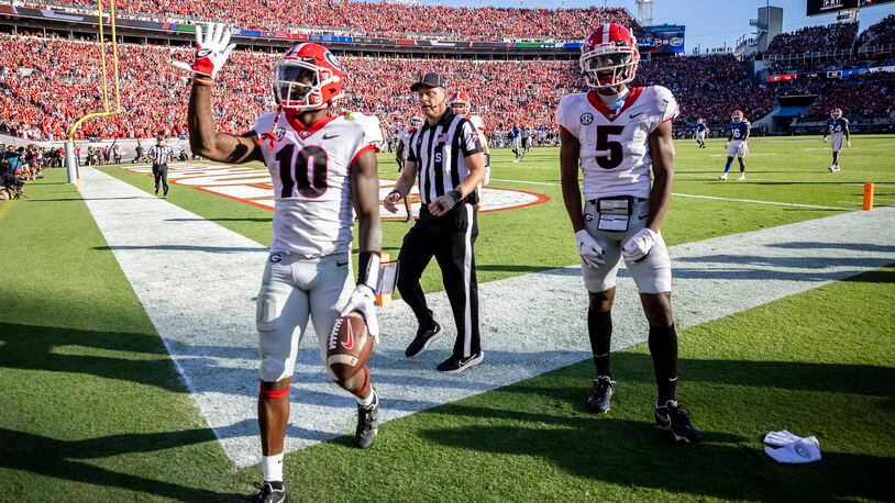 Georgia wide receiver Kearis Jackson (10) celebrates his touchdown with Georgia wide receiver Adonai Mitchell (5) during the first half of an college football game, Saturday, Oct. 30, 2021, in Jacksonville, Fla. (Stephen B. Morton/Atlanta Journal-Constitution)