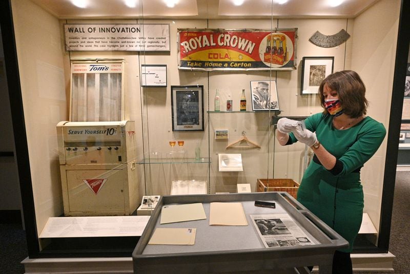Rebecca Bush, curator of history at the Columbus Museum, shows collections of Tom's Foods at the museum on Friday, Feb. 26, 2021. (Hyosub Shin / Hyosub.Shin@ajc.com)
