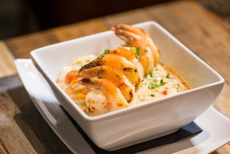 Shrimp and Grits, sauteed shrimp in Gocha's tasty creamy herb tomato sauce served over rich creamy grits. Photo credit- Mia Yakel.