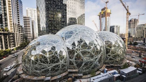 Amazon Tower II rises above the Amazon Biospheres in Seattle. Amazon has been on a building boom in Seattle, but it put a big project there on pause. The company’s reasoning should give a different kind of pause to Georgia, Atlanta and any other locale yearning to land Amazon HQ2, the online giant’s plan for a 50,000-job second headquarters. (Christopher Miller/The New York Times)