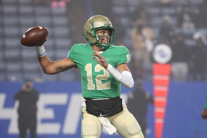 Buford quarterback Ashton Daniels (12) attempts a pass during the first half against Langston Hughes in the Class 6A state title football game at Georgia State Center Parc Stadium Friday, December 10, 2021, Atlanta. JASON GETZ FOR THE ATLANTA JOURNAL-CONSTITUTION