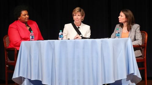 Democratic candidates for governor Stacey Abrams (left) and Stacey Evans (right) with moderator Cathy Cox appear in their first forum since announcing their candidacies on Monday, Oct. 2, 2017, at The Carter Center in Atlanta. Curtis Compton/ccompton@ajc.com