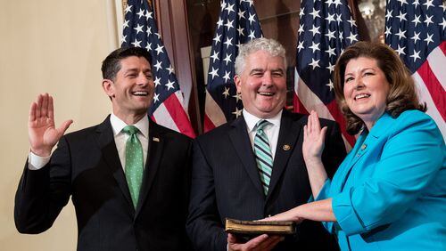 U.S. House Speaker Paul Ryan, from left, Steve Handel and Karen Handel participate in a ceremonial swearing-in June 26 on Capitol Hill. Karen Handel, a Republican, defeated Democrat Jon Ossoff in Georgia’s 6th Congressional District runoff on June 20. (Photo by Drew Angerer/Getty Images)