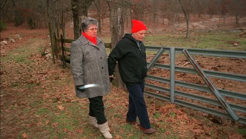 From 1999: Roy Stoner walks his wife Mary back to their home in Adairsville, after Mary visits the grave of their daughter Mary Frances Stoner. The grave is behind their house and up a hill. The girl was raped and murdered when she was 12 years old, which at that point had been 20 years ago.
