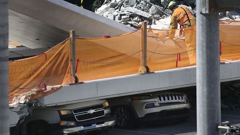 Vehicles are seen trapped under the collapsed pedestrian bridge that was newly built over southwest 8th street allowing people to bypass the busy street to reach Florida International University on March 15, 2018 in Miami, Florida. Reports indicate that there are an unknown number of fatalities as a result of the collapse, which crushed at least five cars. (Photo by Joe Raedle/Getty Images)
