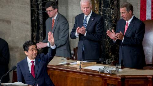 Shinzo Abe, Japan's prime minister, left, waves after speaking during a joint meeting of Congress with U.S. House Speaker John Boehner, a Republican from Ohio, right, and, U.S. Vice President Joseph "Joe" Biden, top left, in the House Chamber at the U.S. Capitol in Washington, D.C., U.S., on Wednesday, April 29, 2015. Abe urged the U.S. to work closely with his country in pushing through an ambitious Asia-Pacific trade deal that he says also will promote both democracy and freedom in that region. Photographer: Andrew Harrer/Bloomberg *** Local Caption *** Shinzo Abe; John Boehner; Joe Biden Shinzo Abe, Japan's prime minister, left, waves after speaking last week during a joint meeting of Congress with U.S. House Speaker John Boehner, a Republican from Ohio, right, and, U.S. Vice President Joe Biden. Abe urged the U.S. to work closely with his country in pushing through an ambitious Asia-Pacific trade deal that he says also will promote both democracy and freedom in that region. Andrew Harrer/Bloomberg