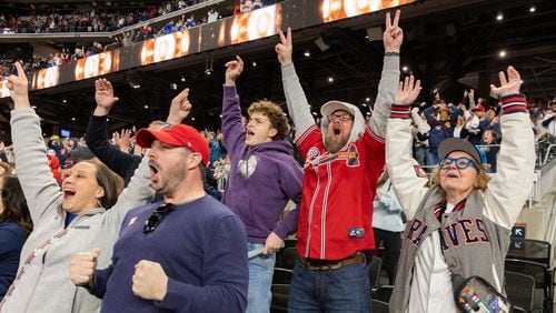Fans react as the Braves clinch the win at the home opening day game versus the Diamondbacks at Truist Park in Atlanta on Friday, April 5, 2024. (Arvin Temkar / arvin.temkar@ajc.com)