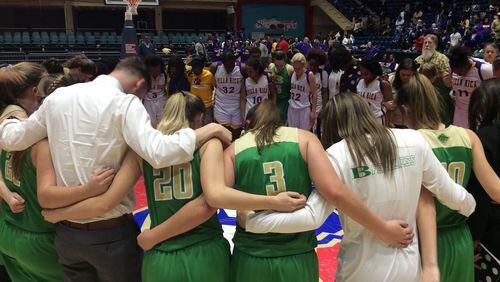 Players from Buford and Villa Rica share a moment on the court together after Buford's 67-59 victory in the Class AAAAA girls basketball state championship game Friday at the Macon Coliseum.