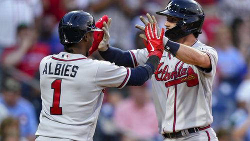 Atlanta Braves' Dansby Swanson, right, celebrates with Ozzie Albies after hitting a grand slam during the third inning of the team's baseball game against the Philadelphia Phillies, Thursday, July 22, 2021, in Philadelphia. (AP Photo/Chris Szagola)