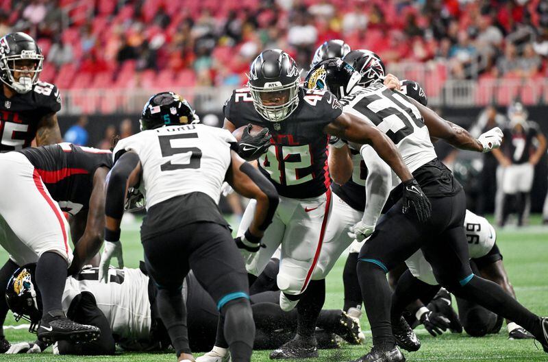August 2 , 2022 Atlanta - Atlanta Falcons' running back Caleb Huntley (42) rushes against Jacksonville Jaguars' safety Rudy Ford (5) during the first half of the final exhibition game of the preseason at Mercedes-Benz Stadium in Atlanta at on Saturday, August 27, 2022. (Hyosub Shin / Hyosub.Shin@ajc.com)