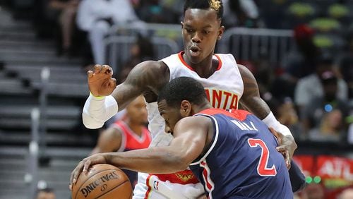 Atlanta Hawks guard Dennis Schroder stops a drive by Washington Wizards guard John Wall in Game 3 of a first-round NBA basketball playoff series on Saturday, April 22, 2017, in Atlanta. The Hawks beat the Wizards 116-98. Curtis Compton/ccompton@ajc.com