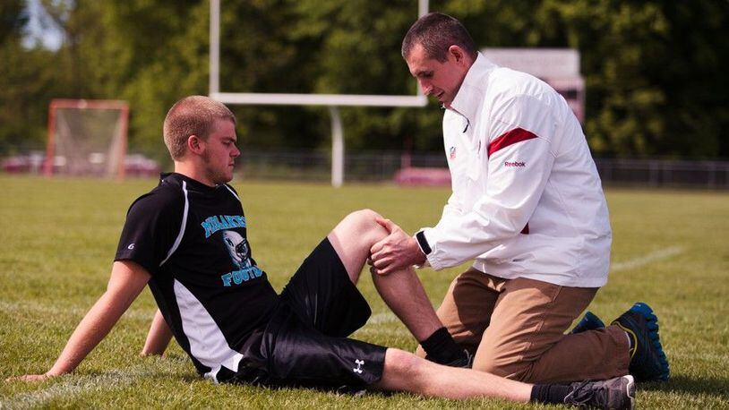 Dr. Christopher Brown works on an injured athlete.