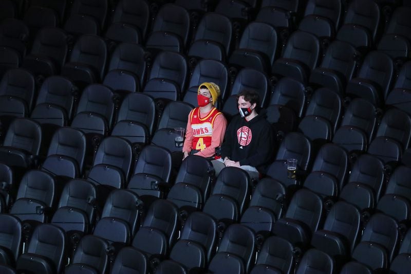The seats are mostly empty with the exception of a few guests while the Atlanta Hawks play their home opener against the Detroit Pistons Monday, Dec. 28, 2020, in Atlanta. (Curtis Compton / Curtis.Compton@ajc.com)
