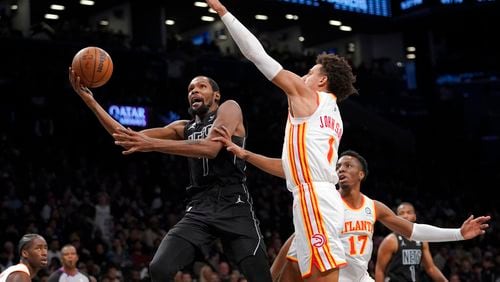 Brooklyn Nets forward Kevin Durant (7) goes to the basket against Atlanta Hawks forward Jalen Johnson (1) during the second half of an NBA basketball game Friday, Dec. 9, 2022, in New York. The Nets won 120-116. (AP Photo/Mary Altaffer)