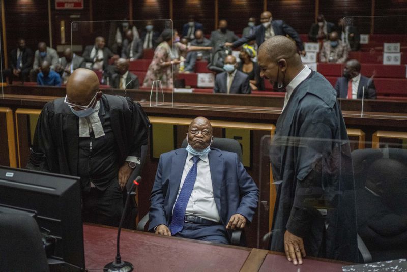 FILE - Former South African President Jacob Zuma, centre, with his legal team in the High Court in Pietermaritzburg, South Africa on Jan. 31, 2022 during a hearing of his corruption trial. For the first time since 1994, the ruling African National Congress (ANC) might receive less than 50% of votes after Zuma stepped down in disgrace in 2018 amid a swirl of corruption allegations and has given his support to the newly-formed UMkhonto WeSiizwe political party. (AP Photo/Jerome Delay, Pool, File)