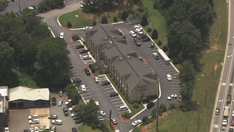 Cobb County police SWAT teams swarmed a motel, where a wanted man was barricaded. (Credit: Channel 2 Action News)