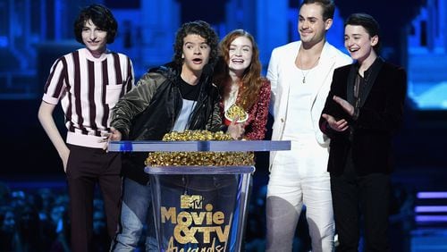 SANTA MONICA, CA - JUNE 16:  (L-R) Actors Finn Wolfhard, Gaten Matarazzo, Sadie Sink, Dacre Montgomery, and Noah Schnapp accept the Best Show award for 'Stranger Things' onstage during the 2018 MTV Movie And TV Awards at Barker Hangar on June 16, 2018 in Santa Monica, California.  (Photo by Kevin Winter/Getty Images for MTV)