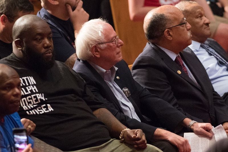 Hip Hop artist Killer Mike, left, U.S. Sen. Bernie Sanders, I-Vt., center, and Atlanta mayoral candidate Vincent Fort sit together during a campaign rally at Saint Phillip AME Church, Saturday, Sept. 30, 2017, in Atlanta. BRANDEN CAMP/SPECIAL