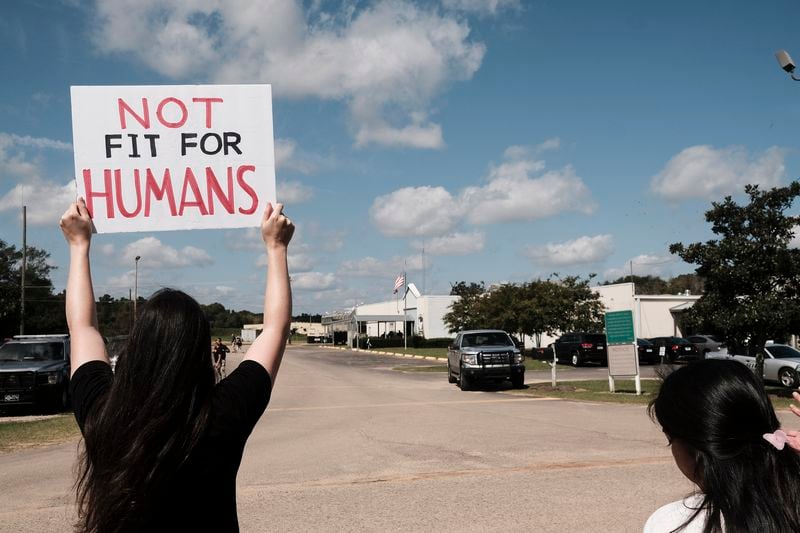 A protester holds a sign saying "Not Fit for Humans" during a demonstration in September 2020 outside the Irwin County Detention Center in Ocilla, Georgia.  (John Arthur Brown/Zuma Press/TNS)