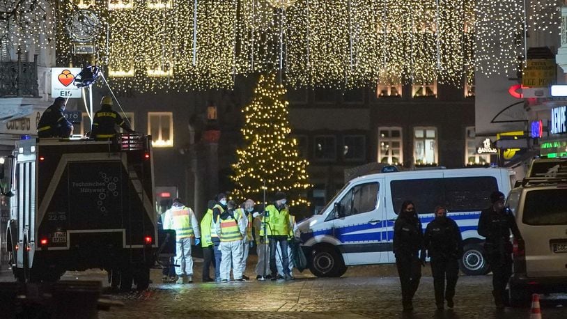 A police car stands in Simeonstrasse pedestrian shopping street following an apparent motorist attack that so far has left four people dead, including one child, and about 15 injured on Dec. 1, 2020 in Trier, Germany. According to witnesses, a man driving an SUV drove through Simeonstrasse at high speed, hitting people apparently at random. Police have arrested the man.