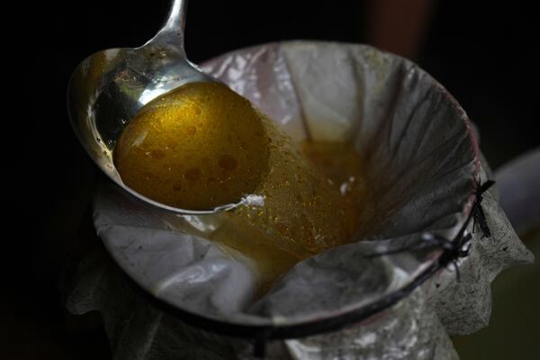 Patchouli oil is filtered at a refinery in Simboro, West Sulawesi, Indonesia, Wednesday, Feb. 26, 2025. (AP Photo/Dita Alangkara)