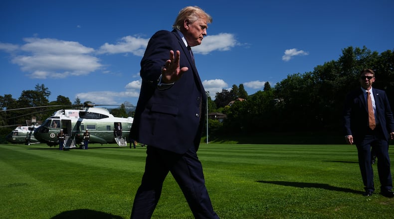 President Donald Trump waves to reporters as he arrives for the G7 summit, Monday, June 15, 2026, in Evian-les-Bains, France. (AP Photo/Julia Demaree Nikhinson)