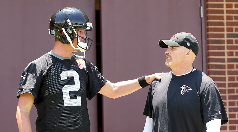 Falcons quarterback Matt Ryan and head coach Dan Quinn confer as they take the field for team practice during. (Curtis Compton/ccompton@ajc.com)