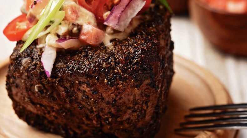Blue cheese and bourbon add intense flavor to the sauce on this filet, but the sauce also dresses the salad vegetables on top. Contributed by Jessica Ebelhar