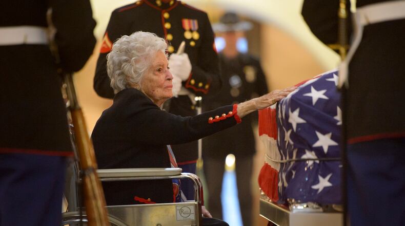 COLUMBUS, OH - DECEMBER 16: In this handout provided by the National Aeronautics and Space Administration (NASA), Annie Glenn, widow of former astronaut and Senator John Glenn, pays her respects to her late husband as he lies in repose, under a United States Marine honor guard, in the Rotunda of the Ohio Statehouse December 16, 2016 in Columbus, Ohio. Glenn, who died at age 95, was the first American to orbit the Earth. He will be honored in a memorial service at Ohio State University's Mershon Auditorium. (Photo by Bill Ingalls/NASA via Getty Images)