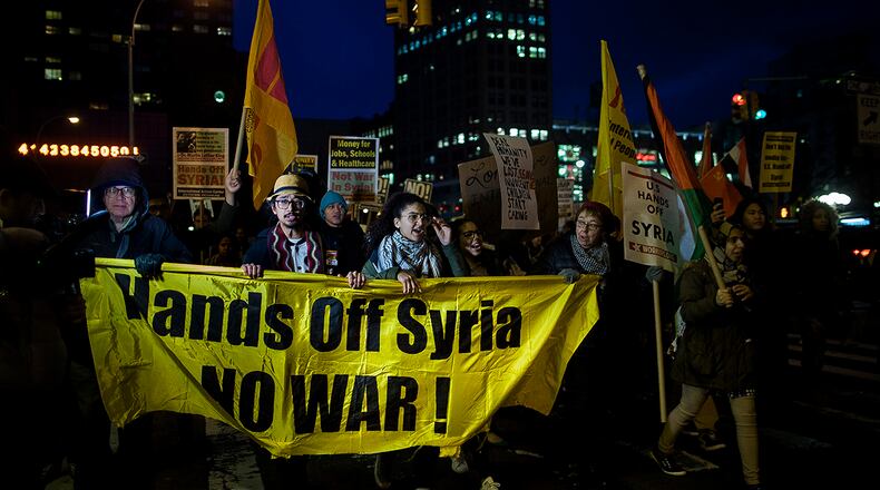 Protesters march during a rally against the U.S. missile strikes in Syria, Friday, April 7, 2017, in New York. The U.S. fired a barrage of cruise missiles into Syria on Thursday night in retaliation for a chemical weapons attack against civilians earlier in the week. (AP Photo/Andres Kudacki)