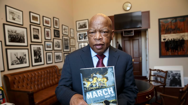 Rep. John Lewis, D-Ga., holds the new installment of his award-winning graphic novel on civil rights and nonviolent protest, on Capitol Hill in Washington. A comic book about Martin Luther King Jr. helped bring John Lewis into the civil rights movement. The longtime Democratic congressman from Georgia now hopes that graphic novels about his life and what his contemporaries endured to overcome racism will guide today's protesters in search of justice. (AP Photo/J. Scott Applewhite)