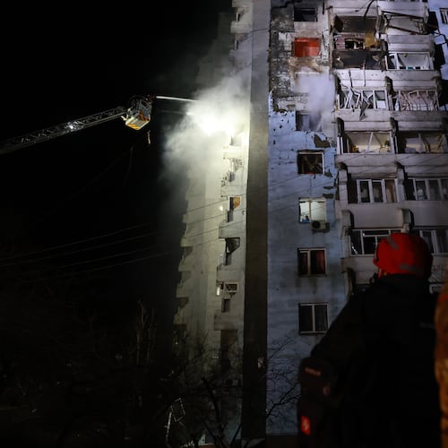 Rescue workers try to put out a fire of a residential building burning after a Russian drone attack on Zaporizhzhia, Ukraine, Tuesday, March 24, 2026. (AP Photo/Kateryna Klochko)