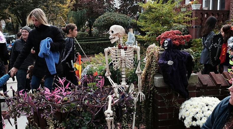 FILE PHOTO:People trick-or-treat in a Brooklyn neighborhood on Halloween night.
