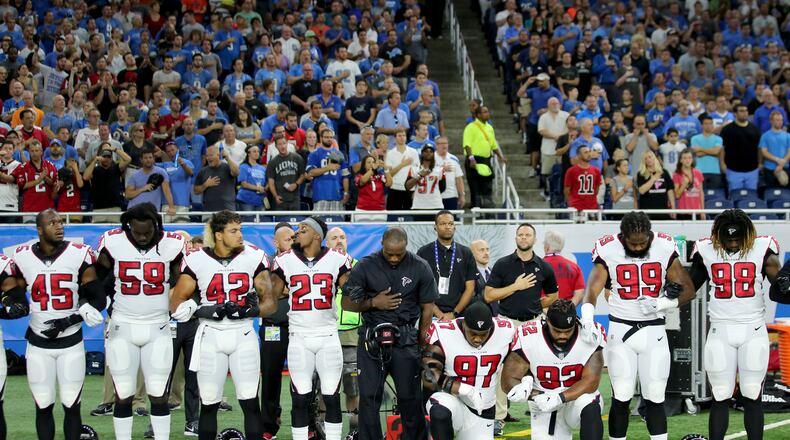 Grady Jarrett and Dontari Poe take a knee during the playing of the national anthem prior to the start of the game against the Detroit Lions at Ford Field on September 24, 2017 in Detroit, Michigan. (Photo by Leon Halip/Getty Images)