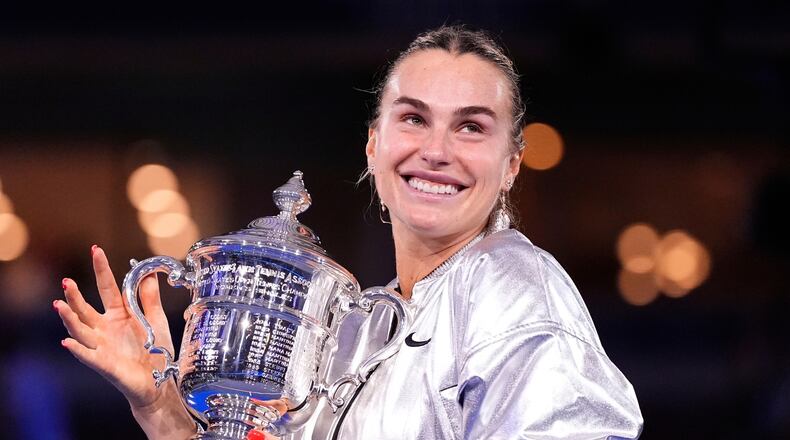 FILE - Aryna Sabalenka, of Belarus, holds her trophy aftyer defeating Amanda Anisimova, of the United States, after the women's finals of the U.S. Open tennis championships, Saturday, Sept. 6, 2025, in New York. (AP Photo/Yuki Iwamura, File)