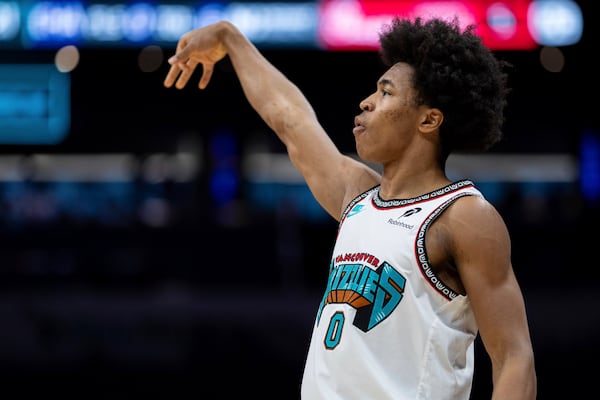 Memphis Grizzlies forward Jaylen Wells (0) watches his shot during the first half of an NBA basketball game against the Charlotte Hornets, Tuesday, April 8, 2025, in Charlotte, N.C. (AP Photo/Jacob Kupferman)