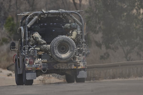 Israeli soldiers drive near the border with the Gaza Strip, in southern Israel, Wednesday, July 2, 2025. (AP Photo/Ohad Zwigenberg)