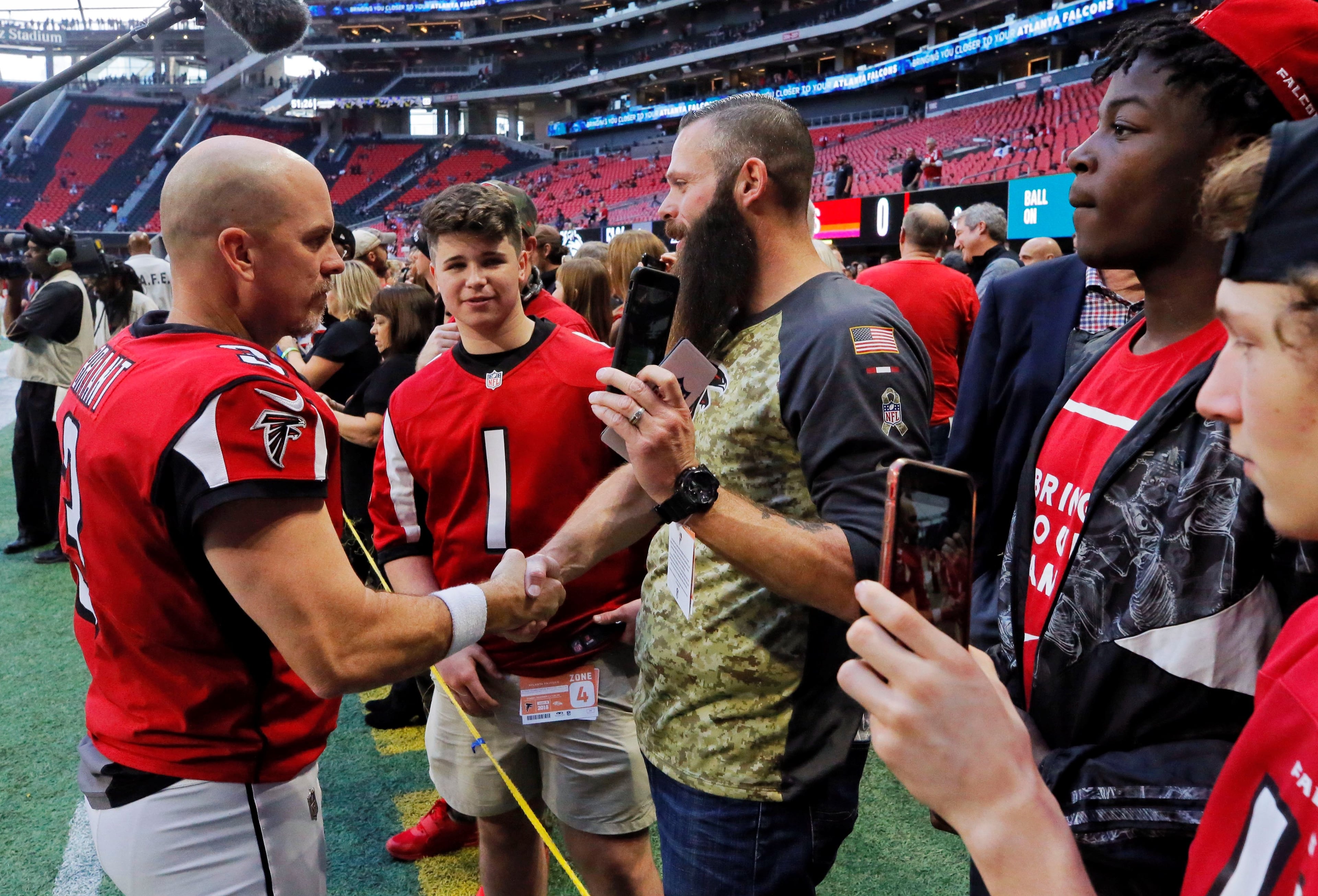 Matt Bryant (left) before a Falcons game in 2018.